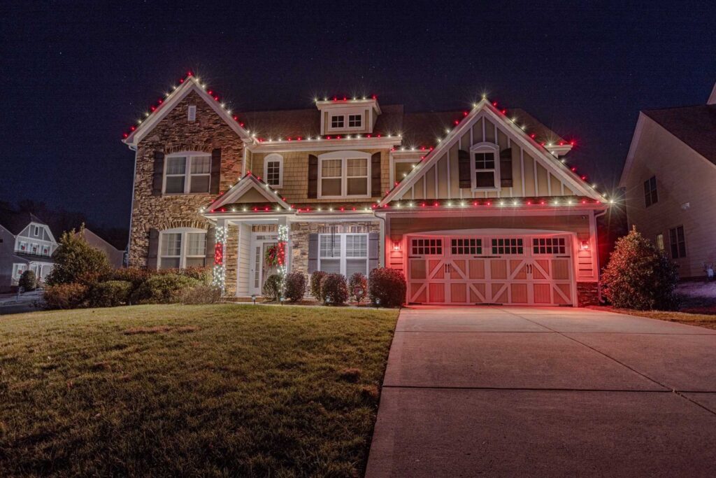 Red and warm white Christmas light installation on a Duluth home